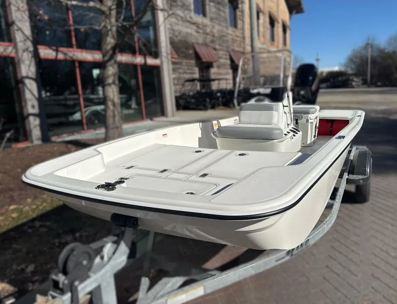 Slide: The Image of 2025 Mako Pro Skiff 15 CC boat on trailer, parked outdoors. - 3
