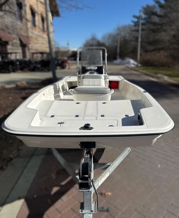 Slide: The Image of 2025 Mako Pro Skiff 15 CC boat on trailer, parked outdoors. - 6