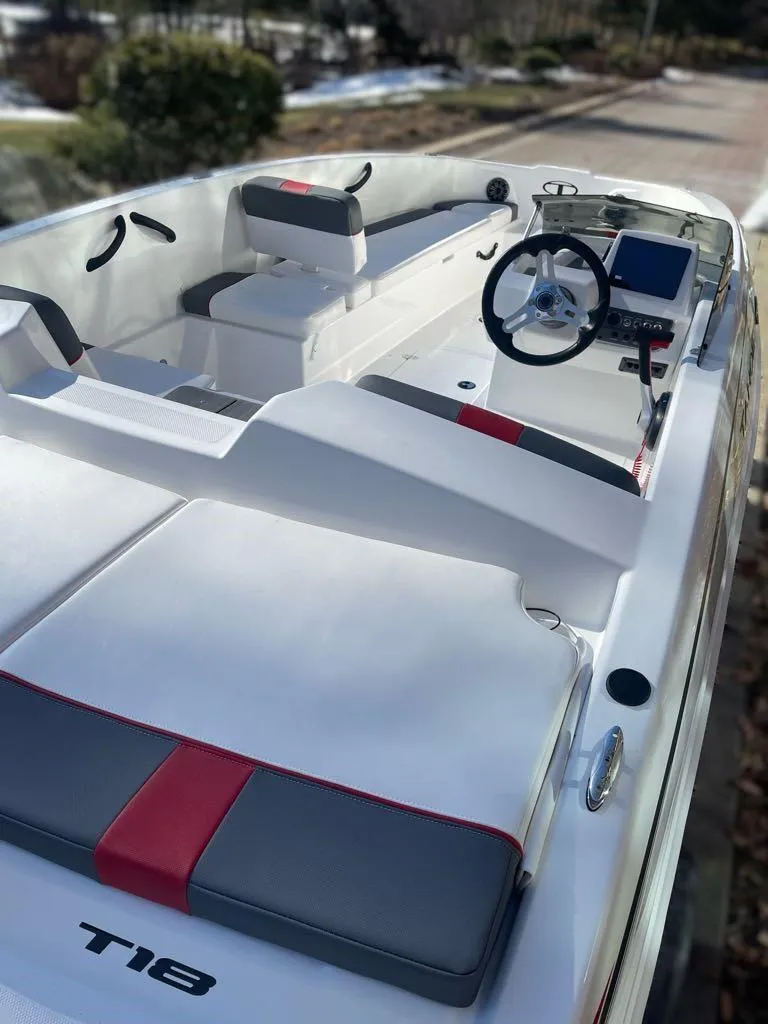 Slide: The Image of 2025 Tahoe T18 boat interior with modern steering and seating, featuring sleek design elements. - 4