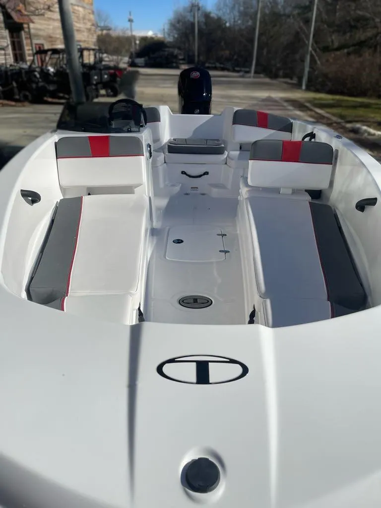 Slide: The Image of 2025 Tahoe T18 boat with sleek white design and red accents, docked outdoors. - 5
