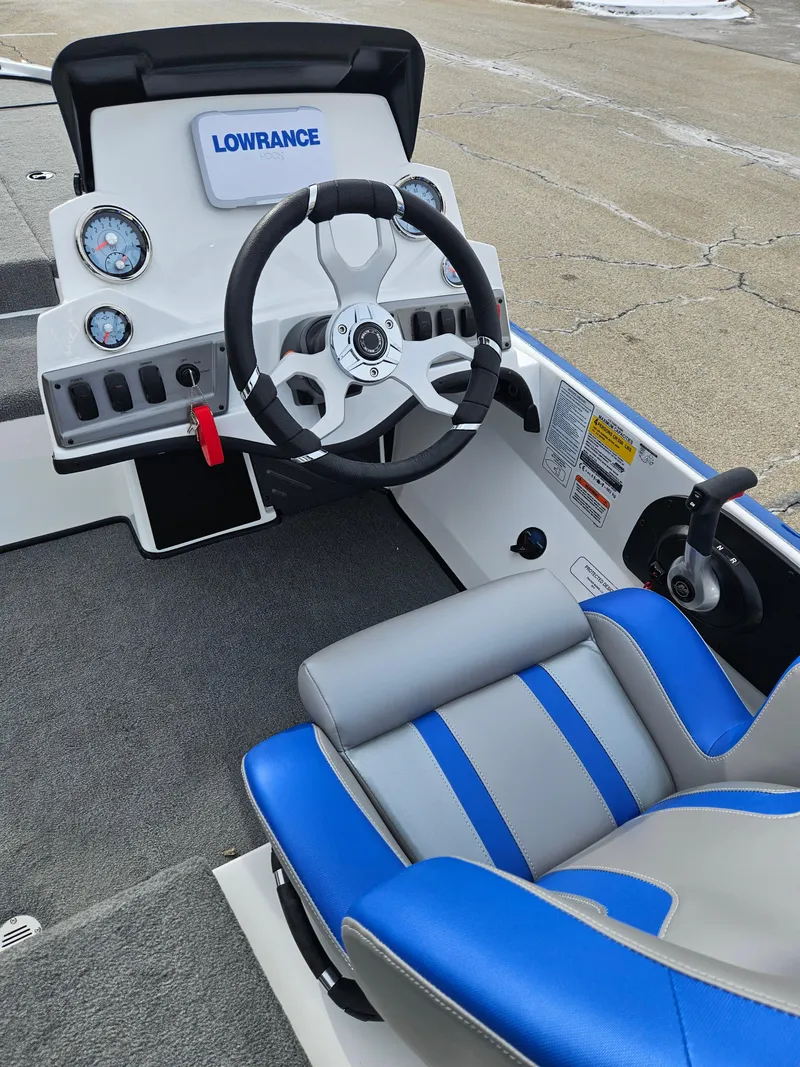 Slide: The Image of 2025 Nitro Z18 boat cockpit with steering wheel, gauges, and blue-gray seating. - 4