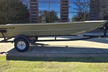 Slide: The Image of 2025 Tracker Grizzly 1754 Jon boat on trailer, parked outdoors. - 24