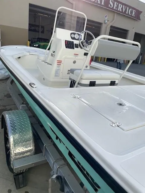 Slide: The Image of 2025 Mako 18 LTS boat on trailer, parked near service center. - 9