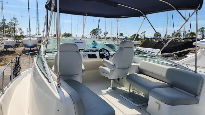 Slide: The Image of 2008 Carver 36 Mariner boat interior with seating and helm, docked at marina. - 10