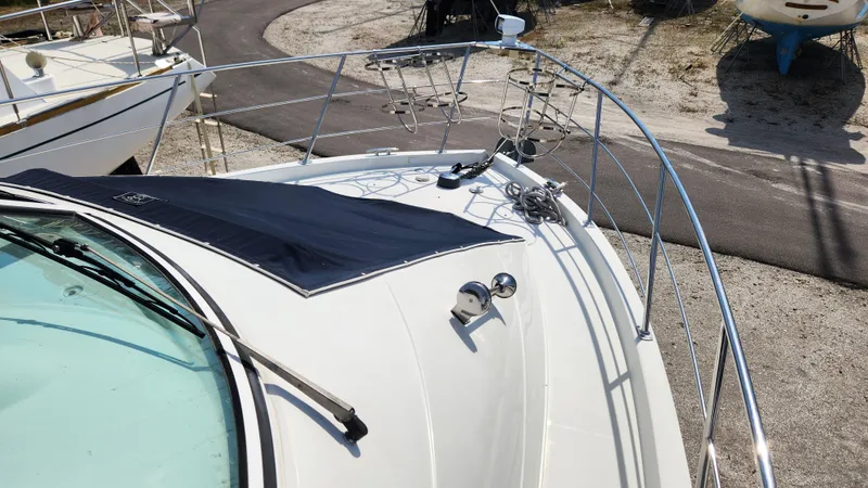 Slide: The Image of 2008 Carver 36 Mariner yacht deck with railing and cover, docked on a sunny day. - 12