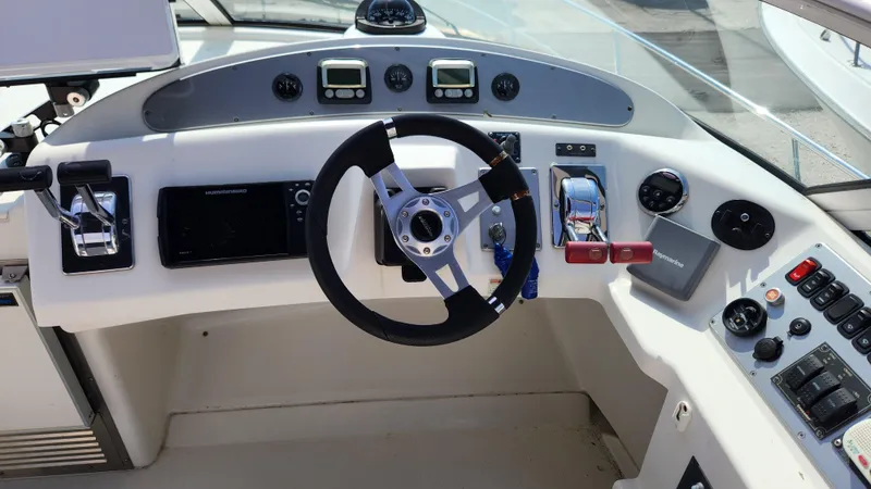 Slide: The Image of Helm of 2008 Carver 36 Mariner with steering wheel and control panel. - 19