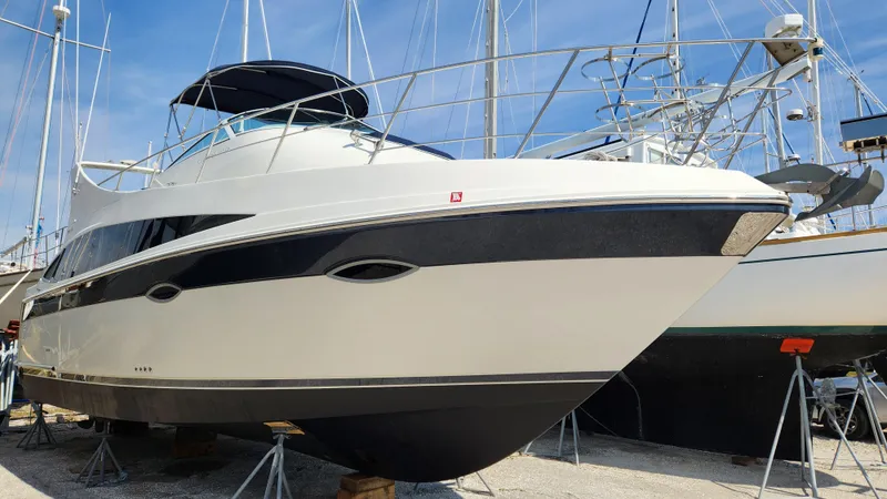 Slide: The Image of 2008 Carver 36 Mariner yacht on stands, marina background, clear sky. - 2