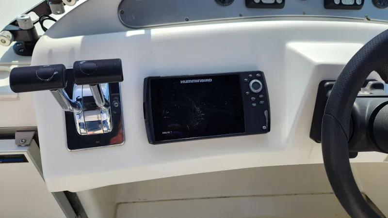 Slide: The Image of Control panel of 2008 Carver 36 Mariner with navigation system and throttle levers. - 21