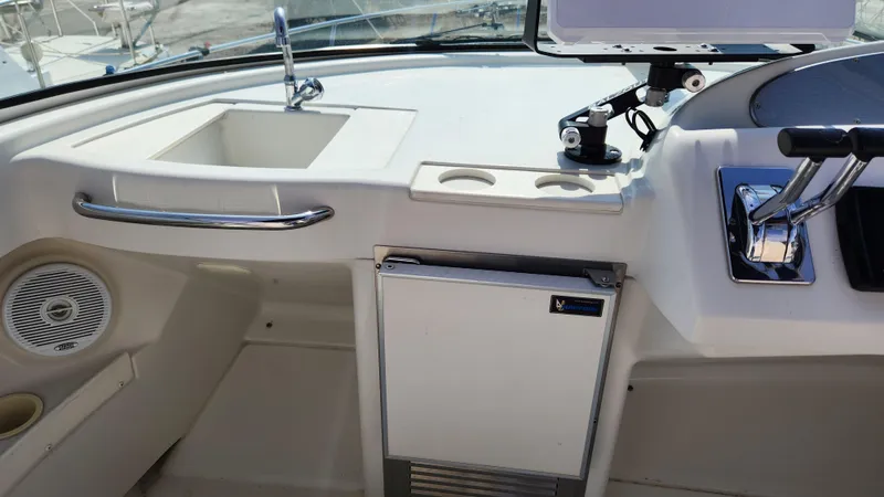 Slide: The Image of 2008 Carver 36 Mariner cockpit with sink, cup holders, and control panel. - 23