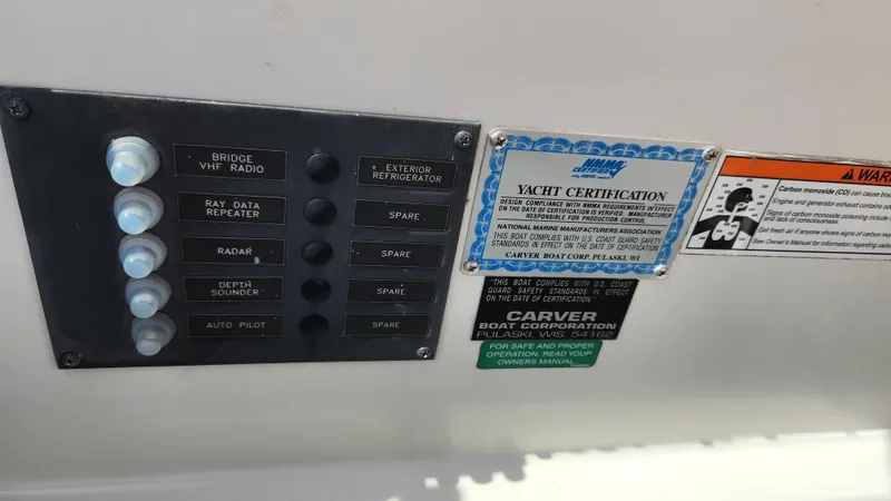 Slide: The Image of Control panel and certification labels on a 2008 Carver 36 Mariner yacht. - 24