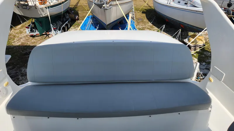 Slide: The Image of 2008 Carver 36 Mariner boat seating area with surrounding docked boats. - 27