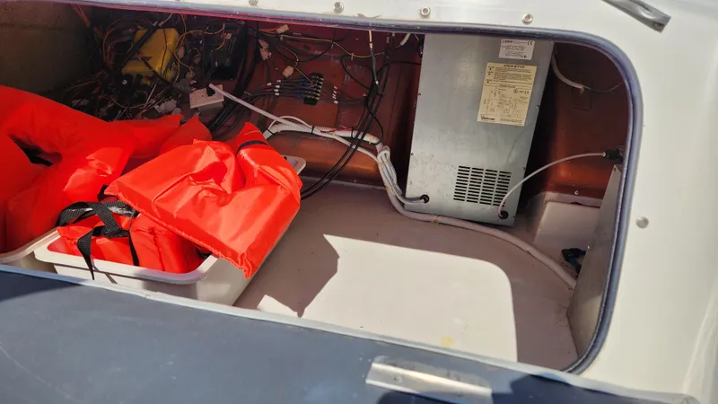 Slide: The Image of Storage compartment of 2008 Carver 36 Mariner with life jackets and electrical equipment. - 28