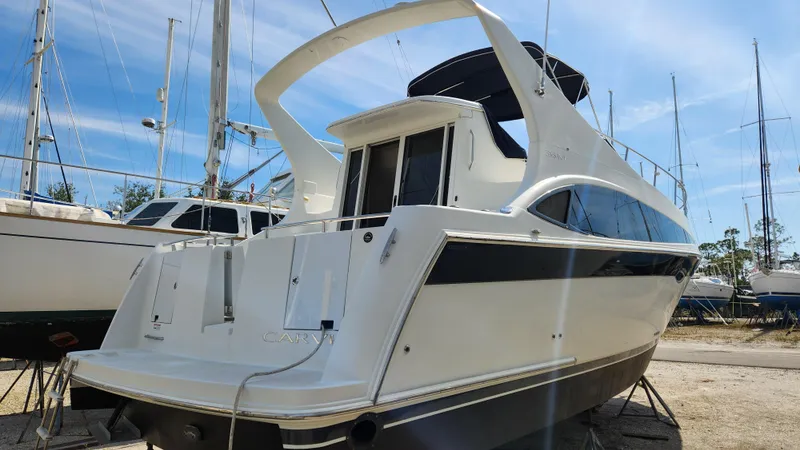 Slide: The Image of 2008 Carver 36 Mariner yacht on land, surrounded by other boats. - 3