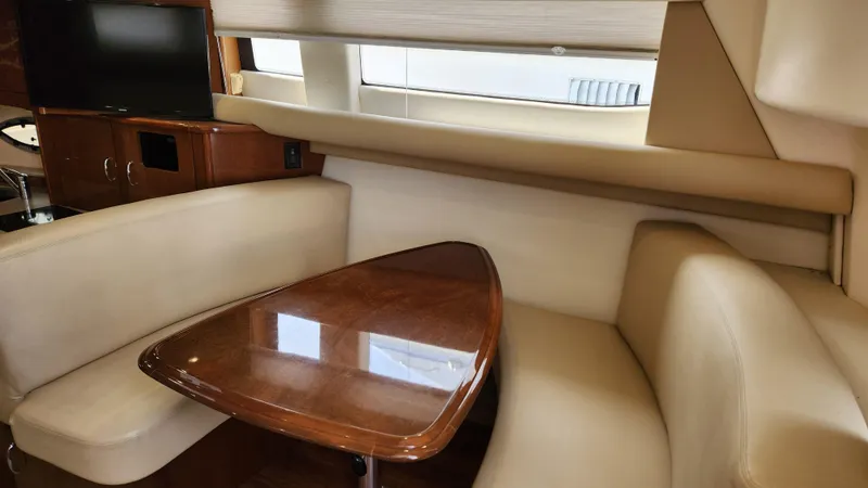 Slide: The Image of Interior of 2008 Carver 36 Mariner yacht with elegant dining area and wooden table. - 32