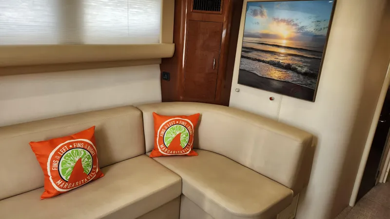 Slide: The Image of Interior of 2008 Carver 36 Mariner with beige seating and sunset artwork. - 34