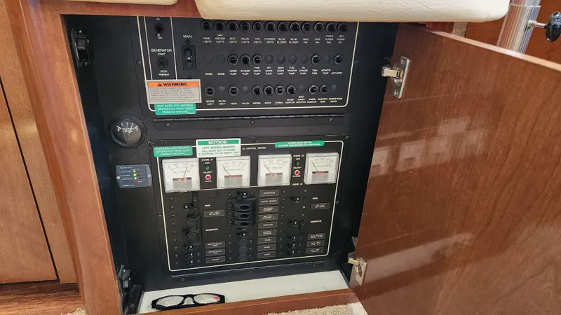 Slide: The Image of Electrical panel inside a 2008 Carver 36 Mariner yacht, featuring various switches and controls. - 35