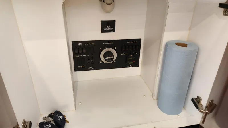 Slide: The Image of Control panel inside a 2008 Carver 36 Mariner boat cabinet with paper towel roll. - 36