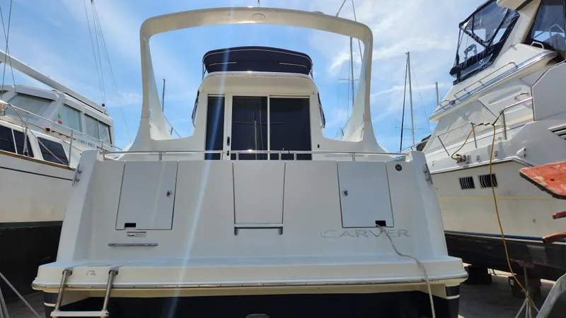 Slide: The Image of 2008 Carver 36 Mariner yacht docked, rear view under clear blue sky. - 4