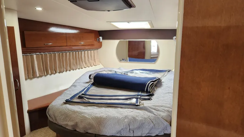 Slide: The Image of 2008 Carver 36 Mariner cabin interior with bed, window, and storage cabinets. - 44
