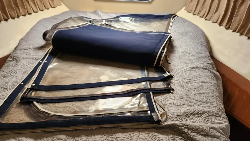 Slide: The Image of 2008 Carver 36 Mariner interior with folded canvas and clear panels on bed. - 45