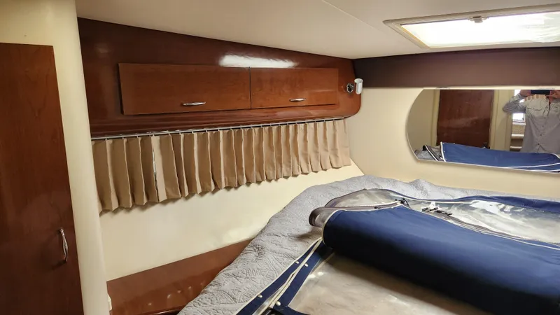 Slide: The Image of Interior cabin of 2008 Carver 36 Mariner with wood cabinets and blue bedding. - 46