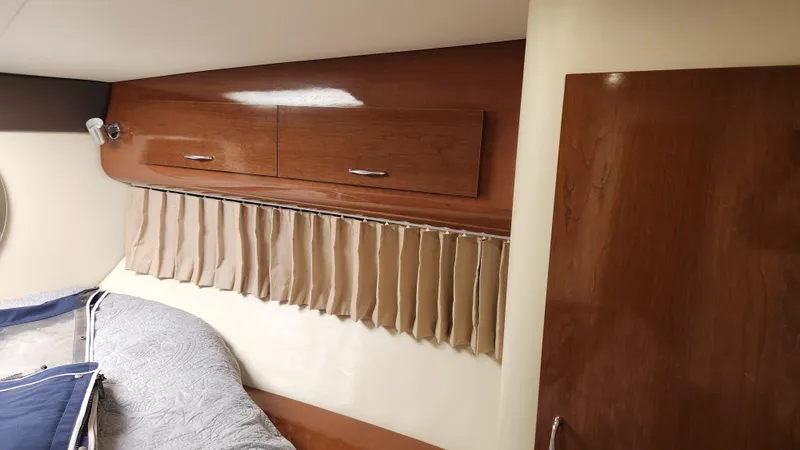 Slide: The Image of Interior cabin of 2008 Carver 36 Mariner with wood paneling and beige curtains. - 47