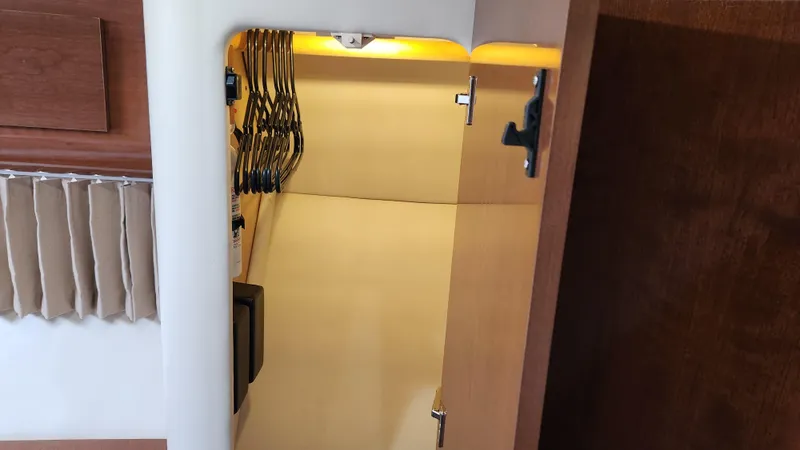 Slide: The Image of 2008 Carver 36 Mariner interior closet with hangers and wooden finish. - 48