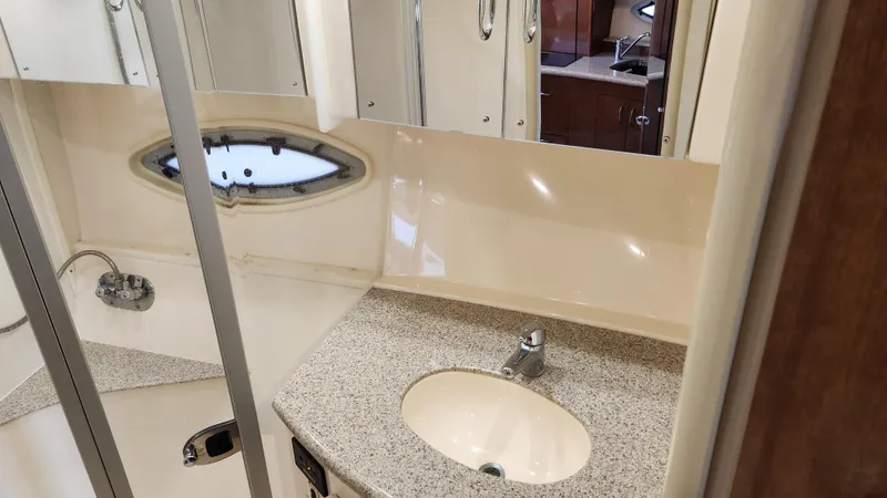 Slide: The Image of 2008 Carver 36 Mariner bathroom with sink, mirror, and porthole window. - 49