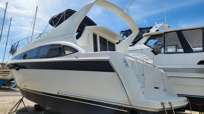 Slide: The Image of 2008 Carver 36 Mariner yacht docked, showcasing sleek design and spacious deck. - 6