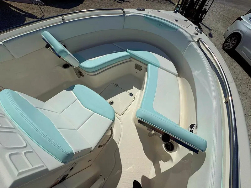Slide: The Image of 2018 Robalo R222 Center Console boat interior with light blue and white seating. - 15
