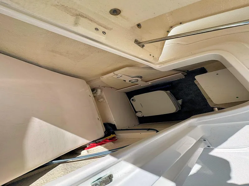 Slide: The Image of 2018 Robalo R222 Center Console interior storage compartment with seating and equipment. - 16