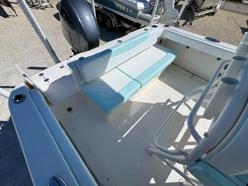 Slide: The Image of 2018 Robalo R222 Center Console boat interior with seating and rod holders. - 5