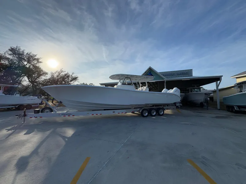 Slide: The Image of 2025 Yellowfin 39 Offshore boat on trailer at marina, under a clear sky. - 15