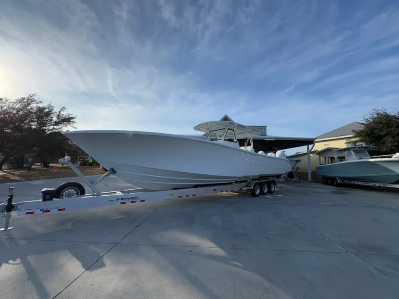Slide: The Image of 2025 Yellowfin 39 Offshore boat on trailer under clear sky. - 17
