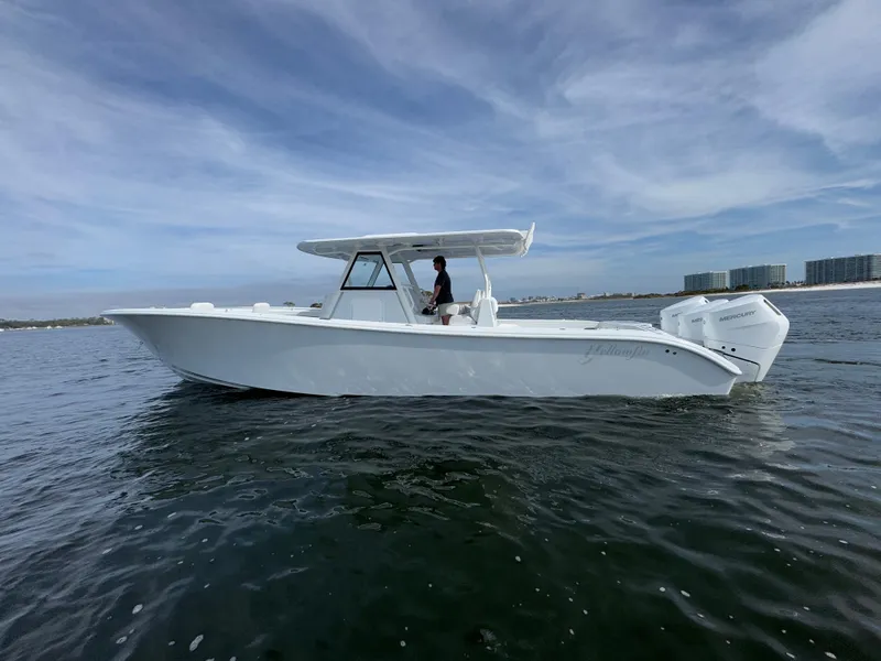 Slide: The Image of 2025 Yellowfin 39 Offshore boat on open water, side view. - 2