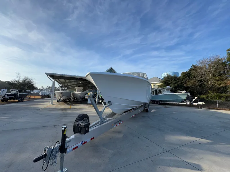Slide: The Image of 2025 Yellowfin 39 Offshore boat on trailer in a marina setting. - 20