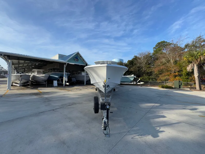 Slide: The Image of 2025 Yellowfin 39 Offshore boat on trailer at marina under clear blue sky. - 22