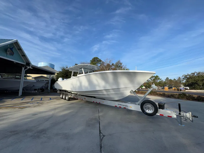 Slide: The Image of 2025 Yellowfin 39 Offshore boat on trailer, parked outdoors under clear sky. - 23