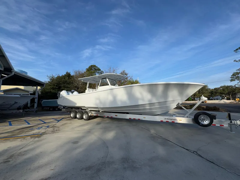 Slide: The Image of 2025 Yellowfin 39 Offshore boat on trailer under clear blue sky. - 24