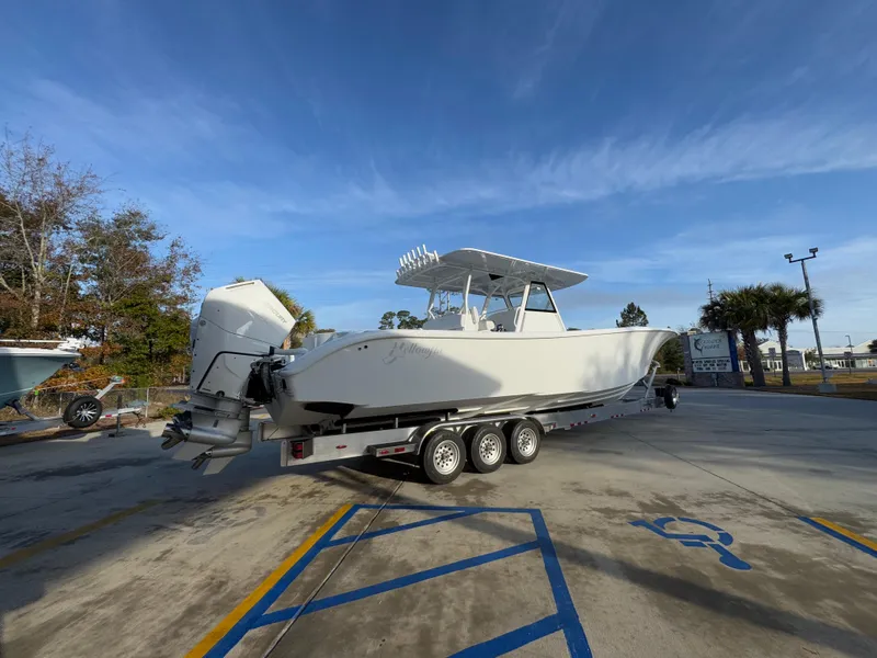 Slide: The Image of 2025 Yellowfin 39 Offshore boat on a trailer in a parking lot. - 28