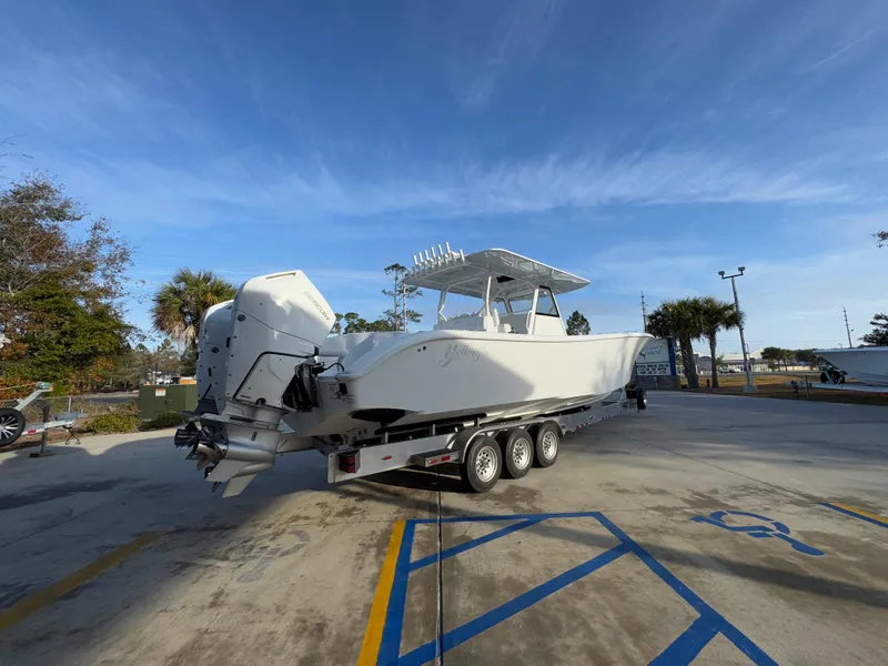 Slide: The Image of 2025 Yellowfin 39 Offshore boat on trailer, parked outdoors under clear blue sky. - 29
