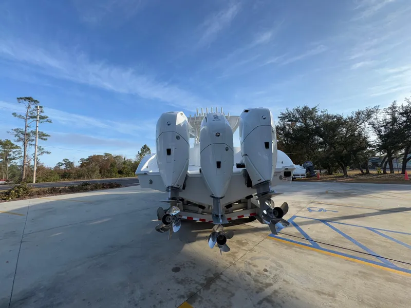 Slide: The Image of 2025 Yellowfin 39 Offshore boat with four powerful outboard engines, parked outdoors. - 33