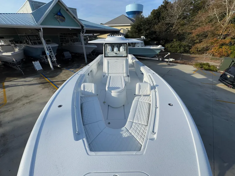 Slide: The Image of 2025 Yellowfin 39 Offshore boat with spacious deck and seating, displayed outdoors. - 37