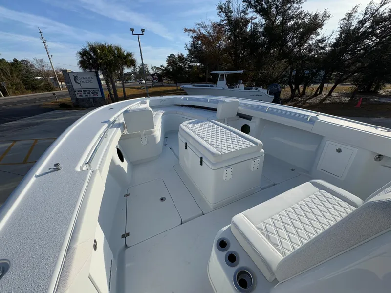 Slide: The Image of 2025 Yellowfin 39 Offshore boat interior with white seating and storage compartments. - 39