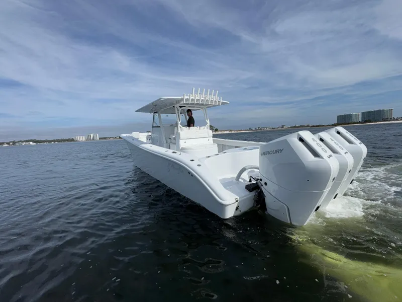 Slide: The Image of 2025 Yellowfin 39 Offshore boat with triple Mercury engines on open water. - 4