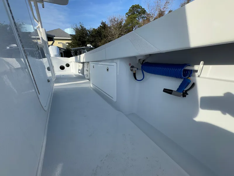Slide: The Image of 2025 Yellowfin 39 Offshore boat deck with storage and coiled hose. - 42