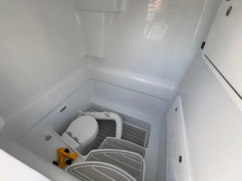 Slide: The Image of 2025 Yellowfin 39 Offshore boat interior with compact marine toilet and storage. - 46