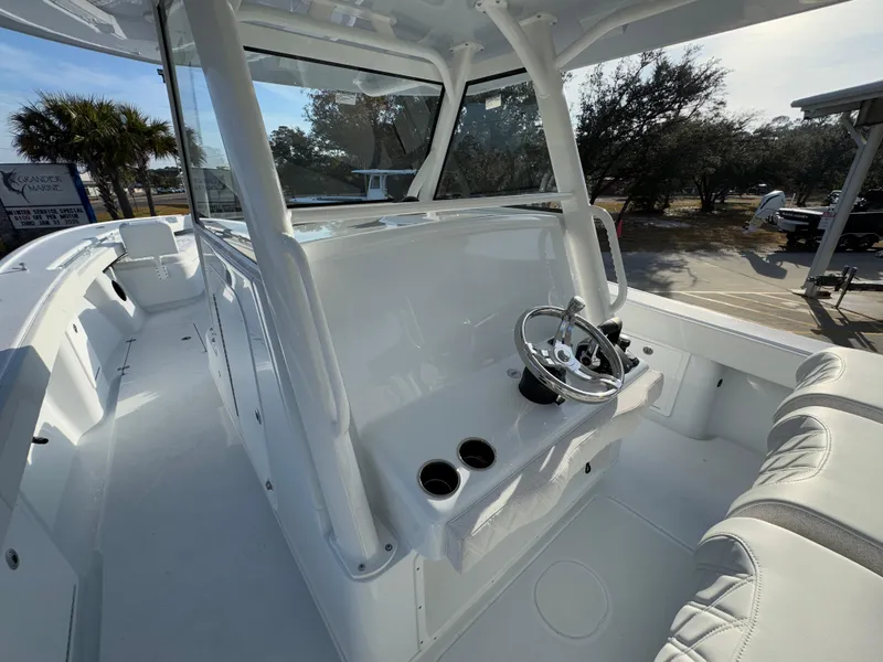 Slide: The Image of 2025 Yellowfin 39 Offshore boat interior with steering wheel and seating. - 49