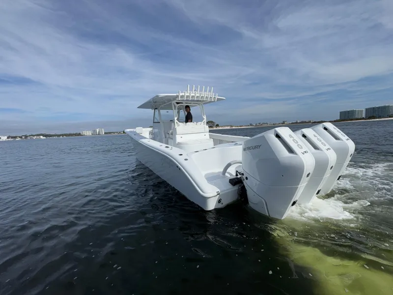 Slide: The Image of 2025 Yellowfin 39 Offshore boat cruising on open water with triple outboard engines. - 5