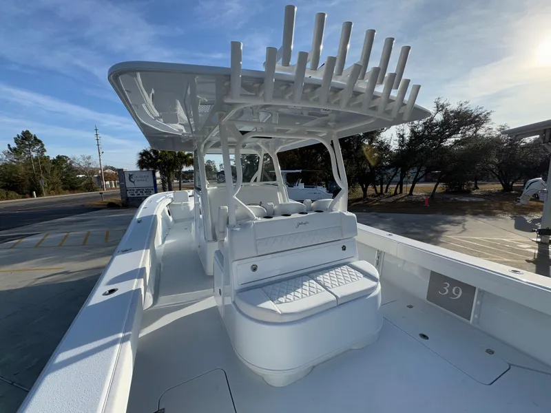Slide: The Image of 2025 Yellowfin 39 Offshore boat with spacious deck and seating, parked outdoors. - 52